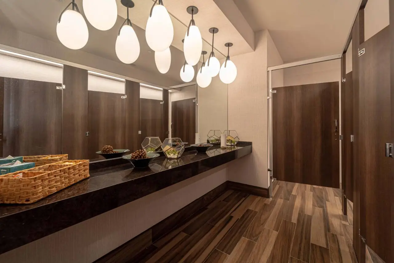 Commercial restroom with wood finishes and lighting