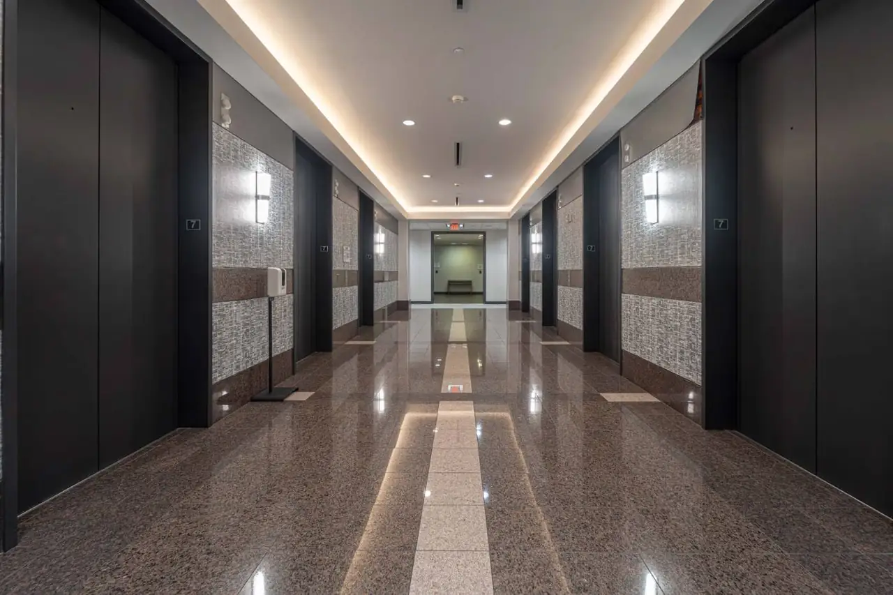 Commercial lobby with marble finishes and recessed lighting